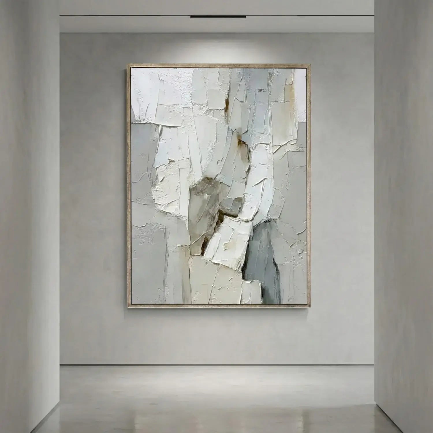 Abstract art piece in a neutral-toned frame on a gray wall