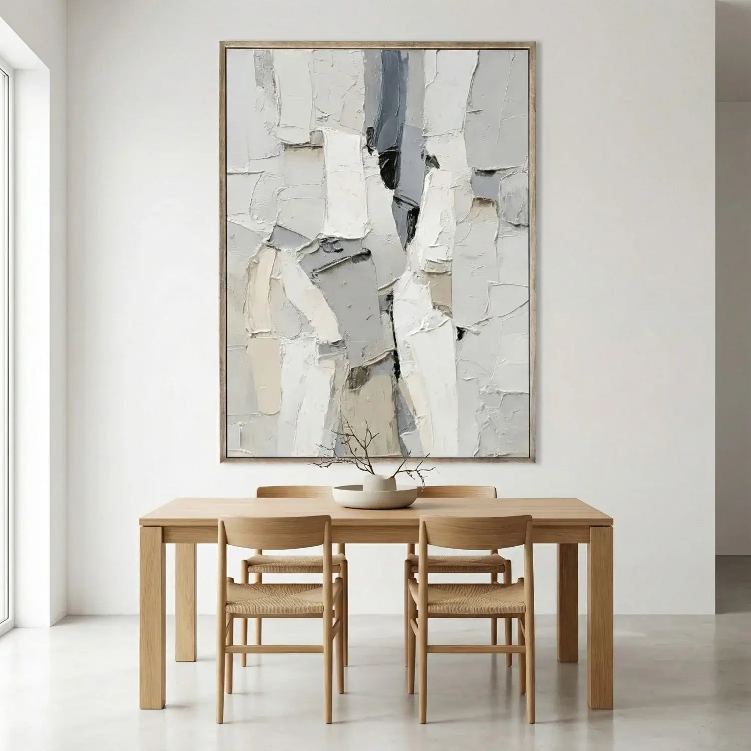 Dining room with wooden table and chairs, abstract art on the wall.