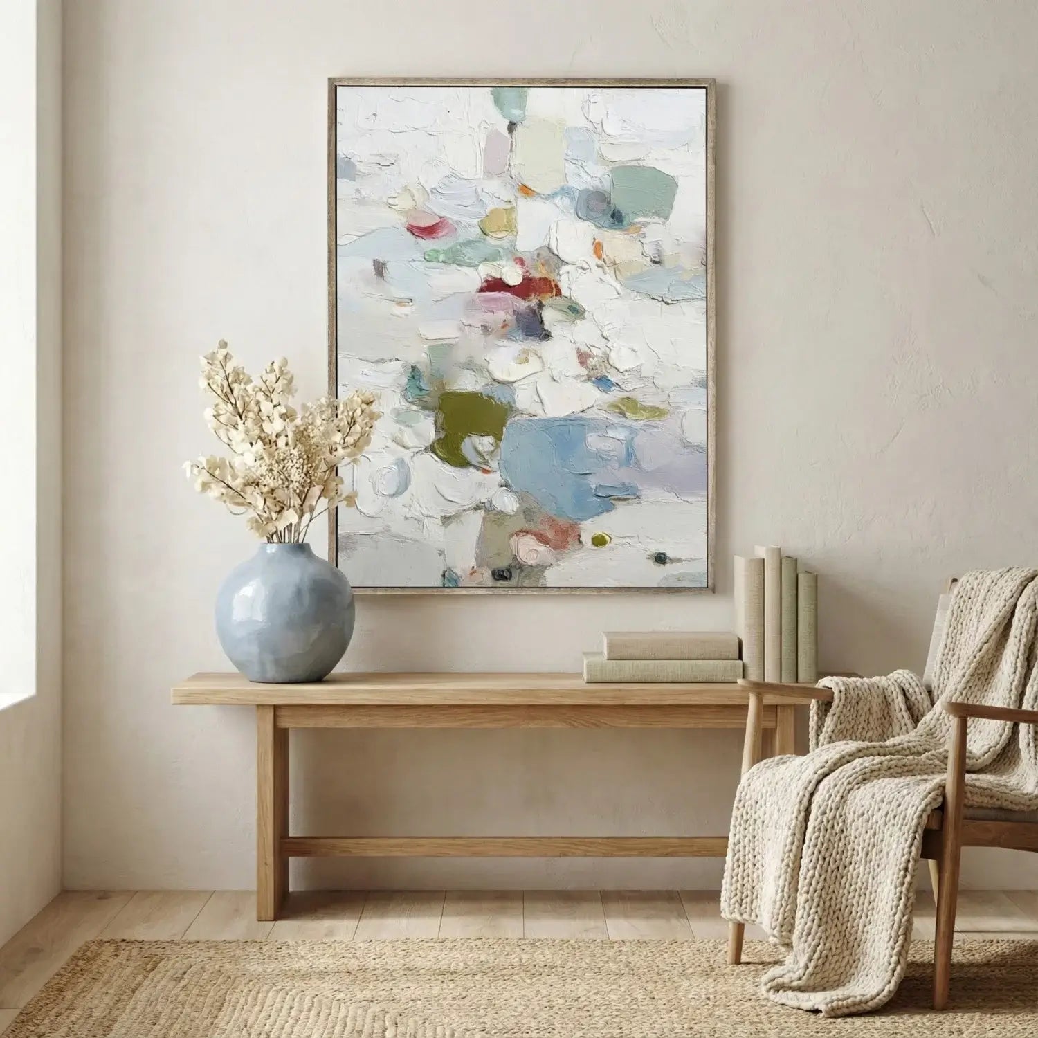 Living room with abstract art, vase, and chair