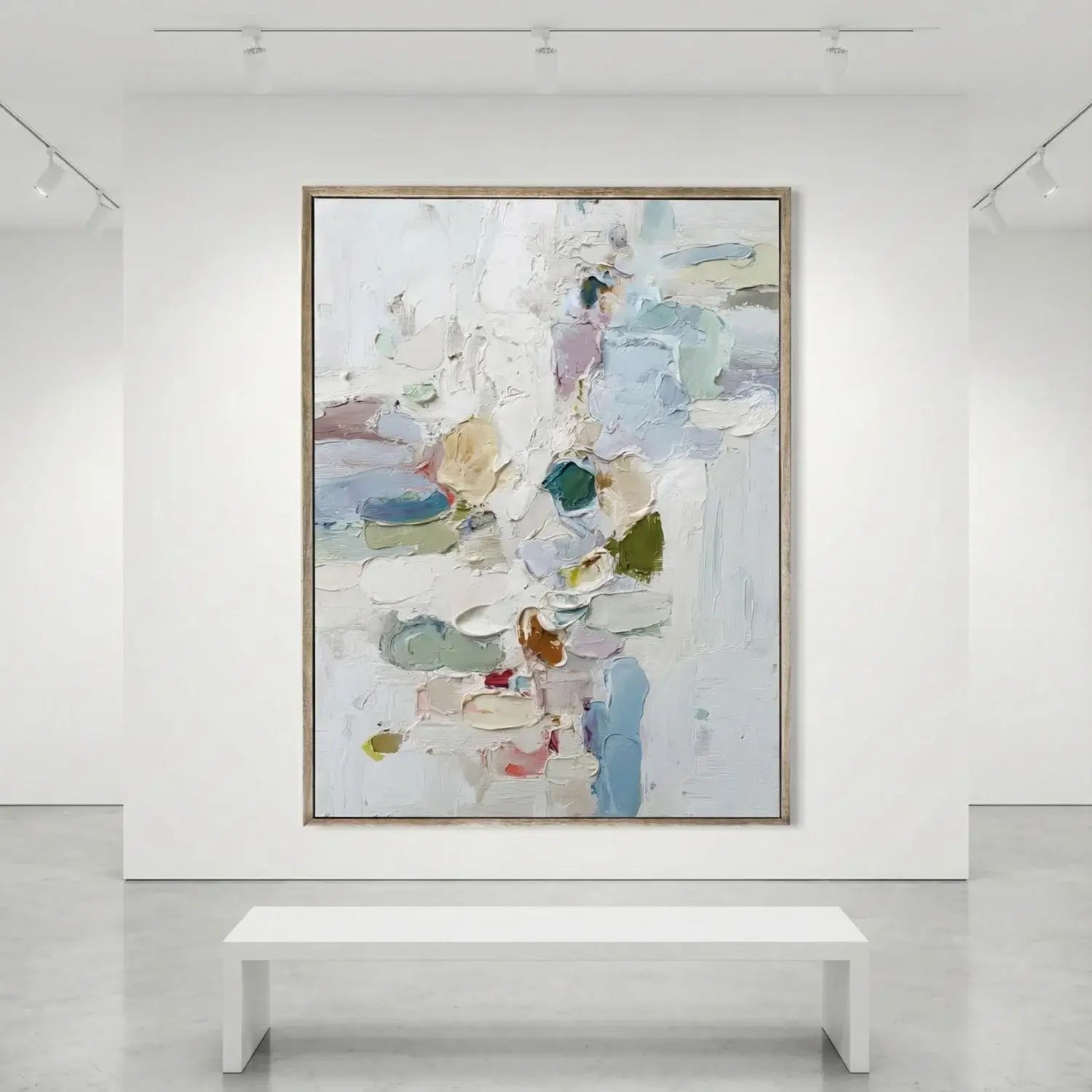 Abstract painting in a modern interior setting with a white bench.