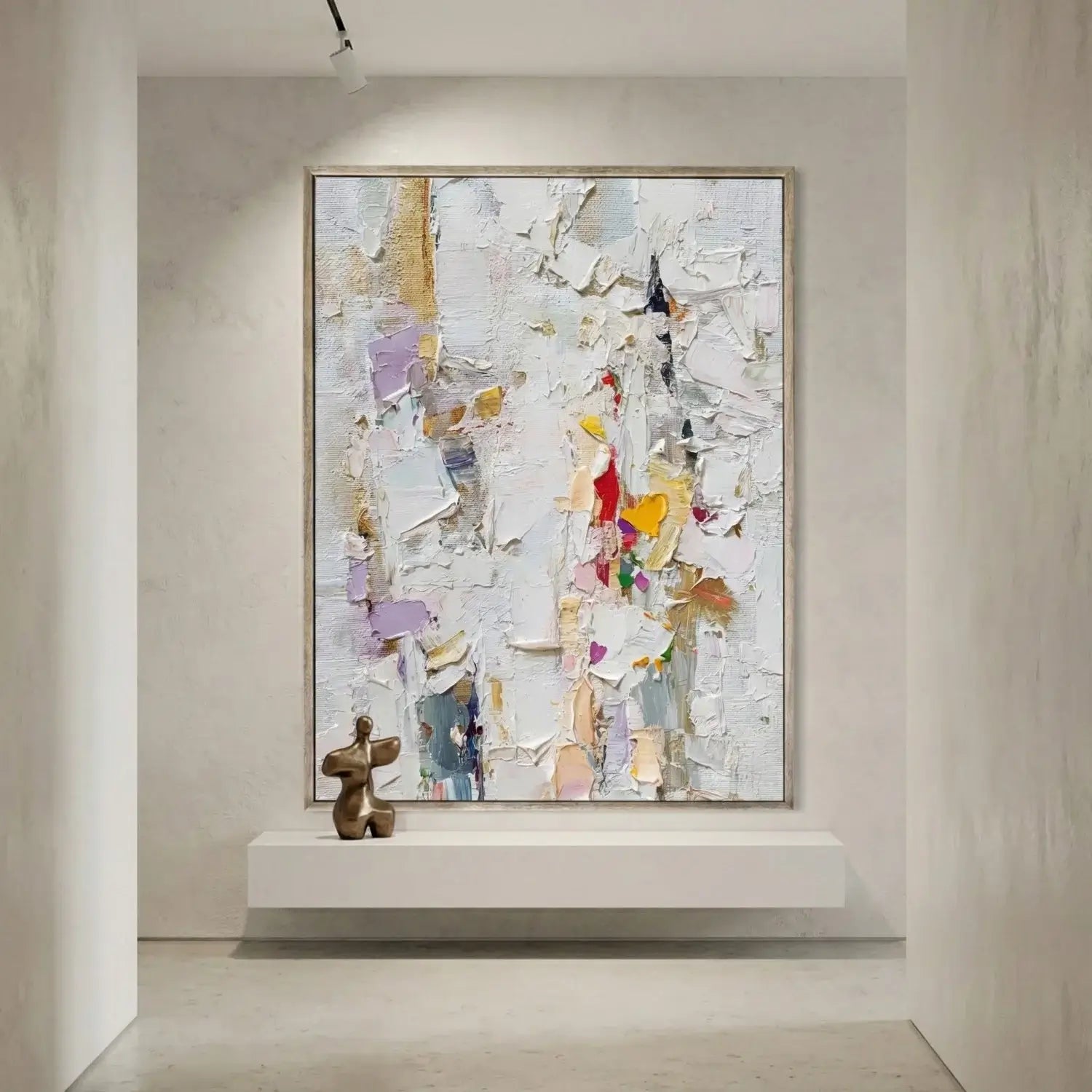 Abstract painting in a modern interior setting with a sculpture on a shelf.