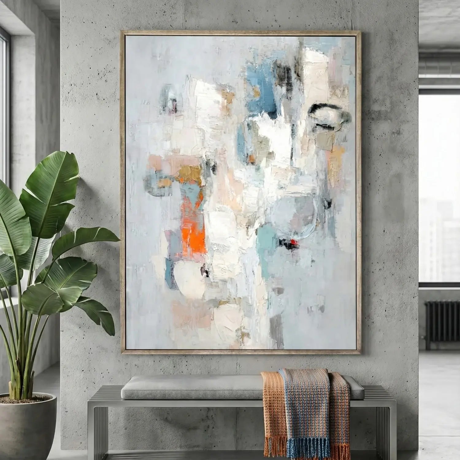 Abstract painting in a modern interior setting with a plant and bench.
