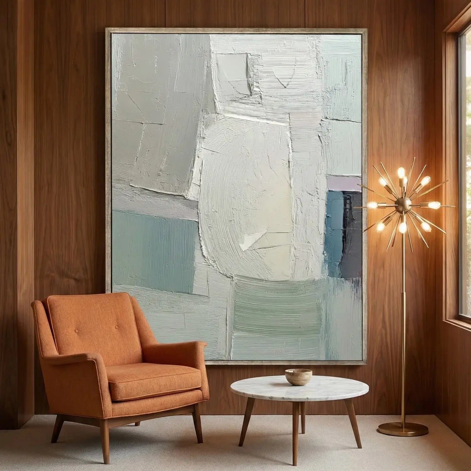 Modern living room with an abstract painting, orange armchair, and marble coffee table.