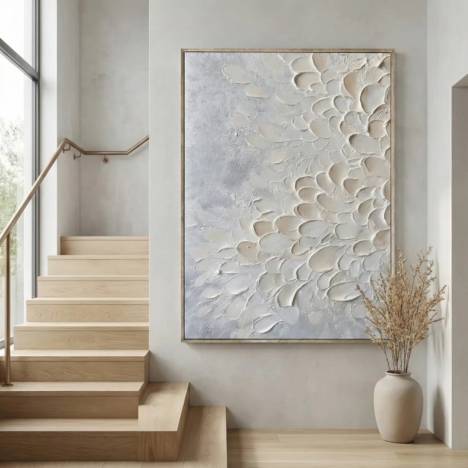 Abstract wall art in a modern interior setting with wooden stairs and a vase.