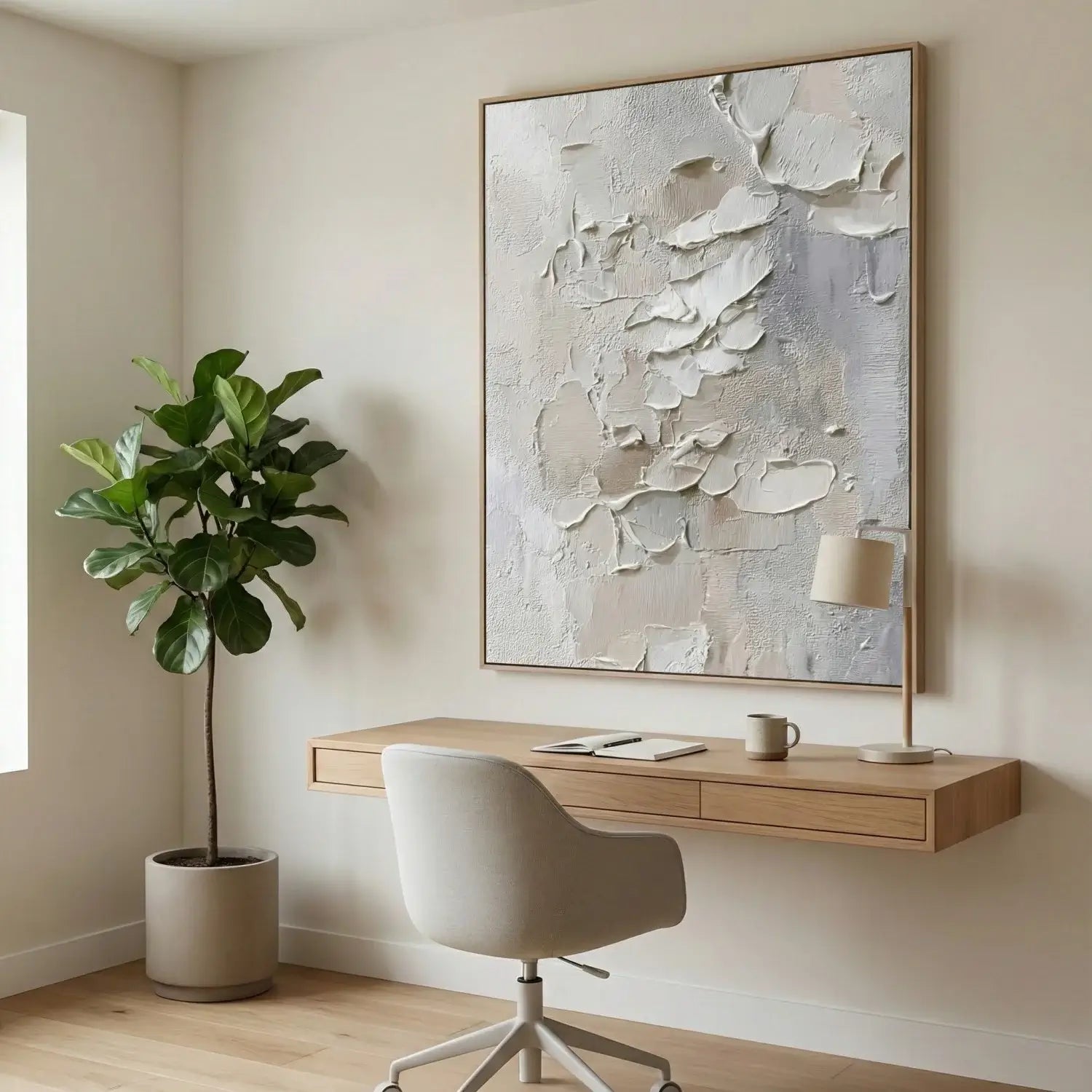 Modern home office with a desk, chair, and abstract painting on a neutral wall.