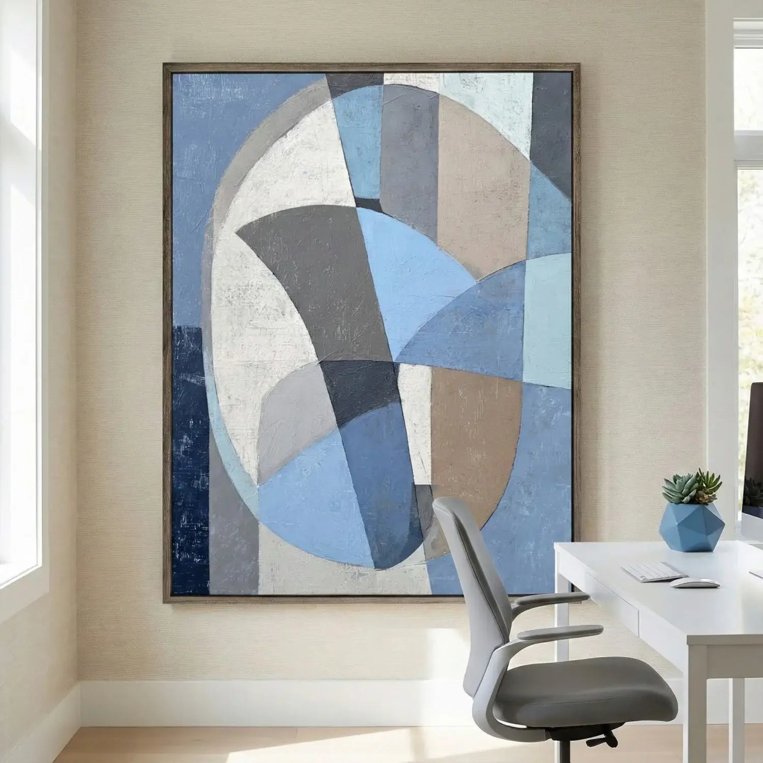 Abstract art piece in a modern office setting with a chair and desk.