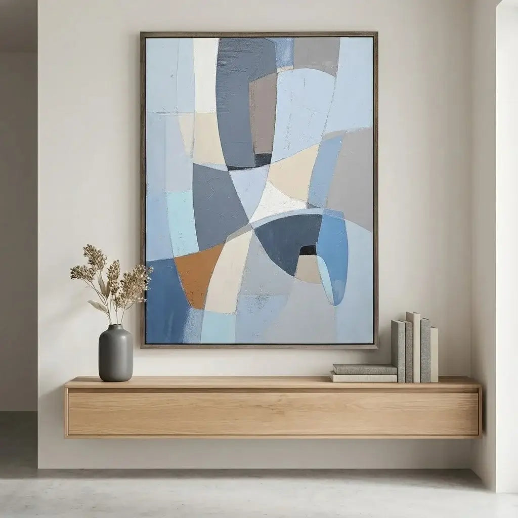 Abstract art piece on a wall above a wooden console table with decorative items.