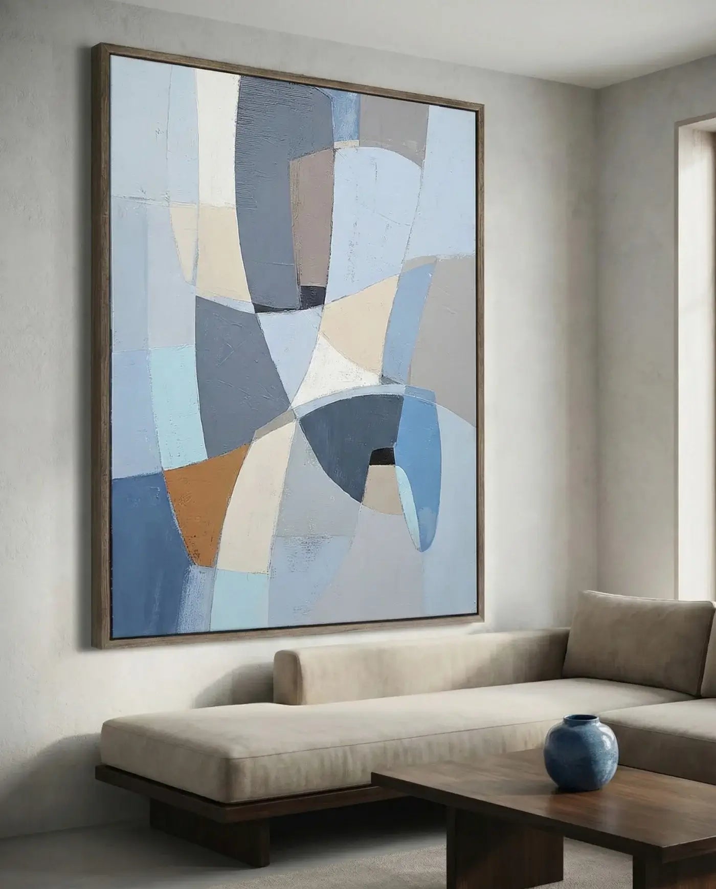 Abstract art piece on a wall above a sofa in a living room.