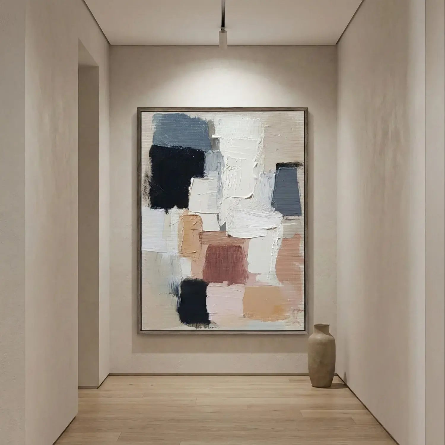 Abstract art piece on a wall in a minimalistic room with a vase on the floor.