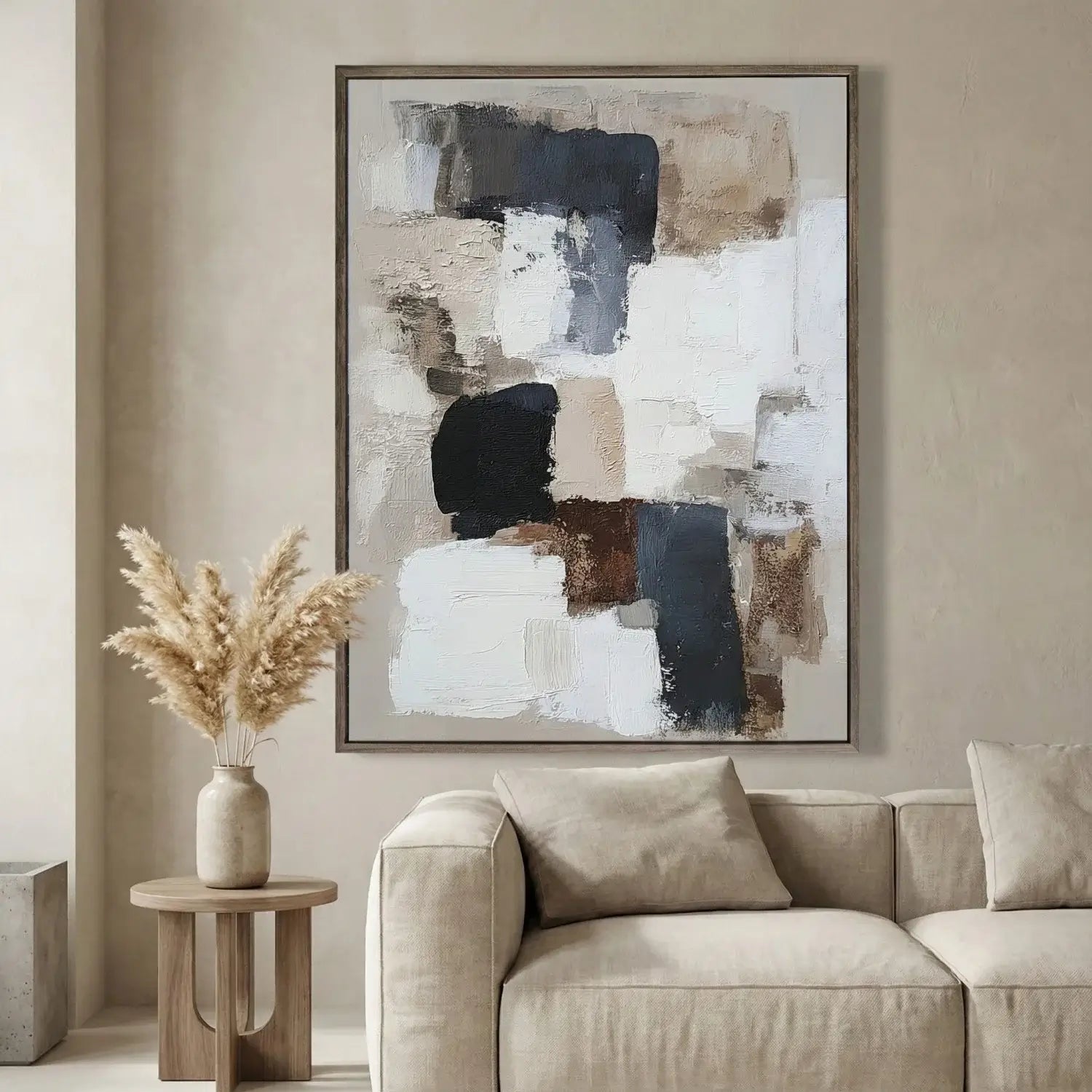 Abstract painting on a wall above a beige sofa in a living room.