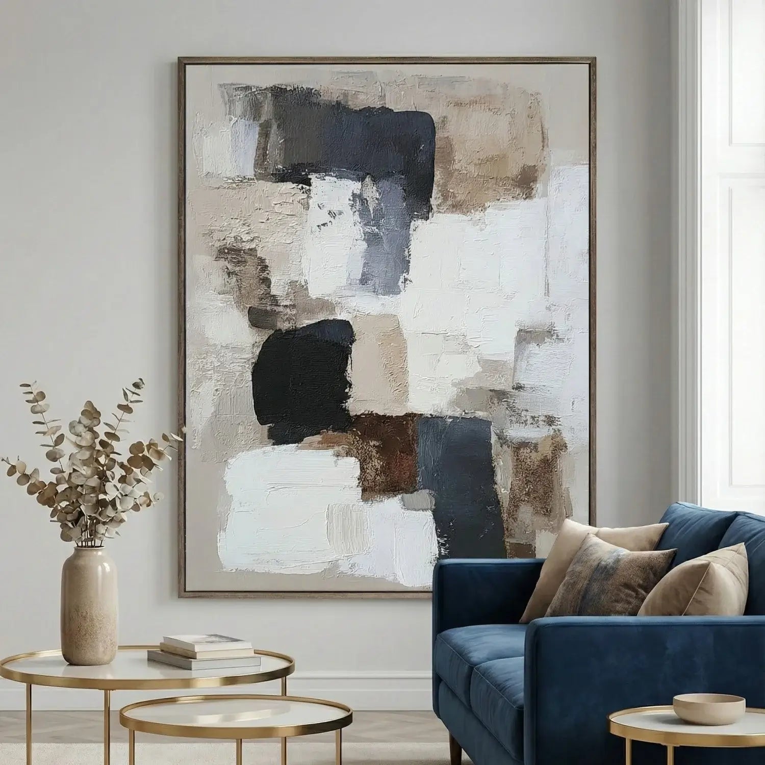 Modern living room with abstract art, blue sofa, and decorative items.