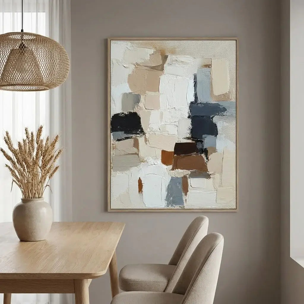 Dining room with abstract art on the wall, wooden table, and chairs.
