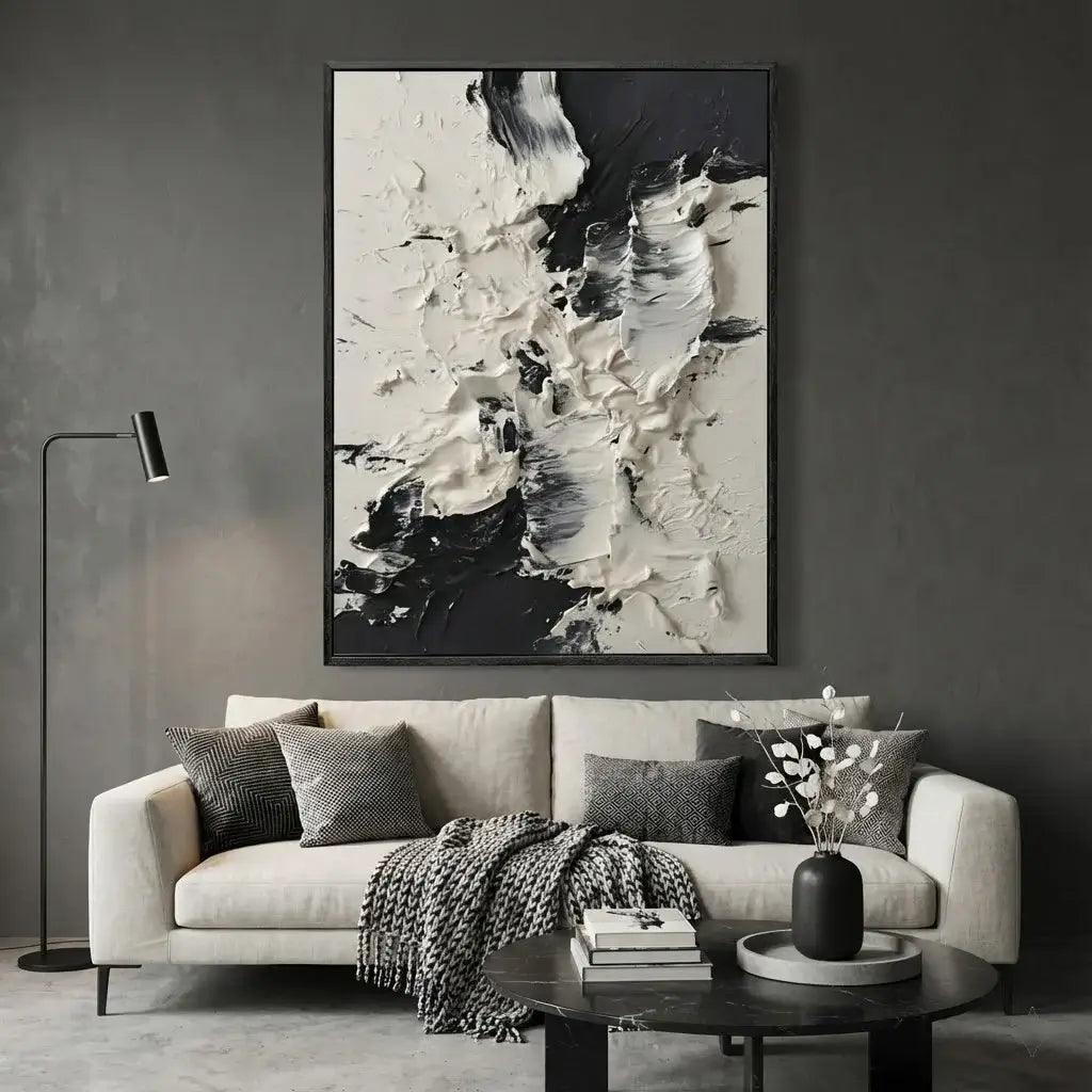 Living room with a gray sofa, abstract art on the wall, and decorative items.