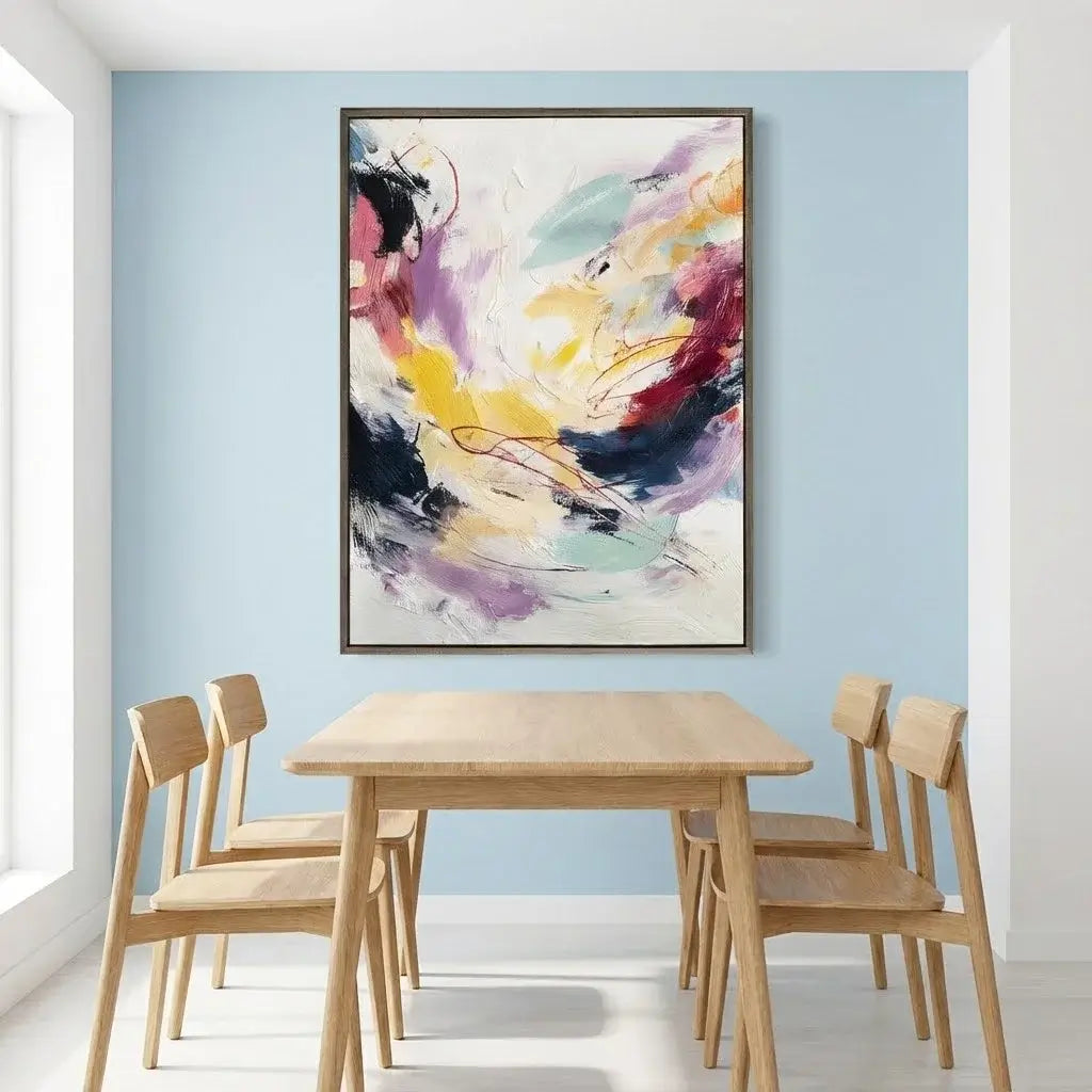 Dining room with a wooden table and chairs, and a colorful abstract painting on the wall.