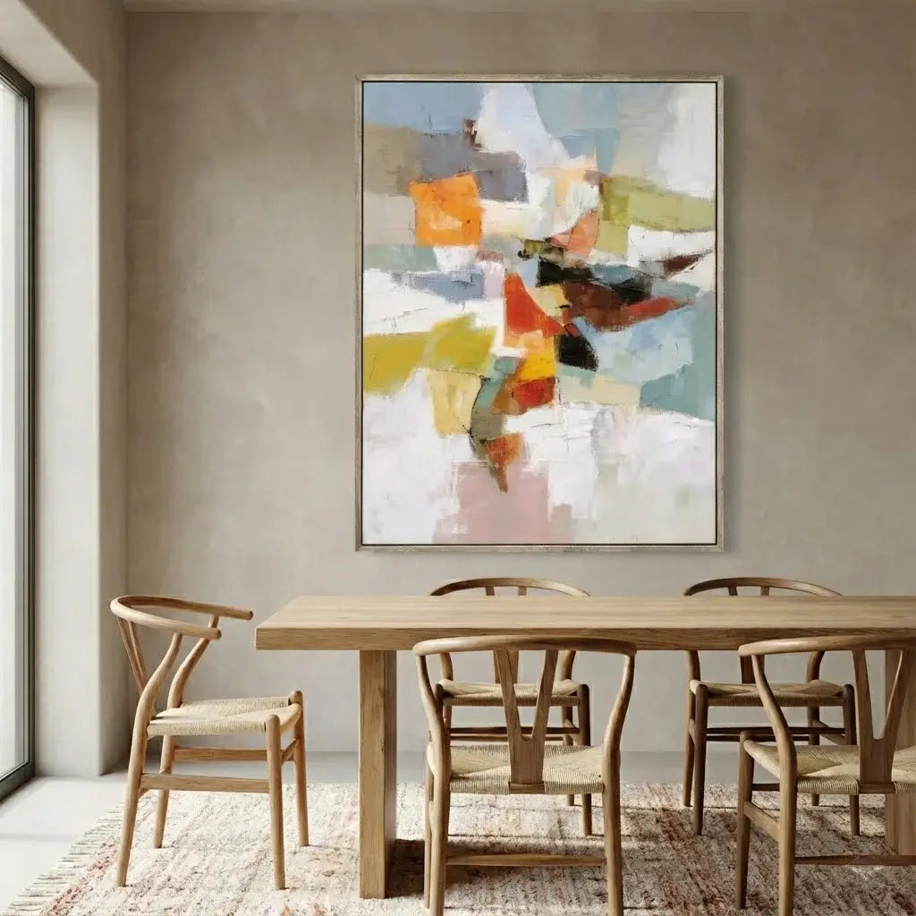 Dining room with a wooden table and chairs, and a colorful abstract painting on the wall.