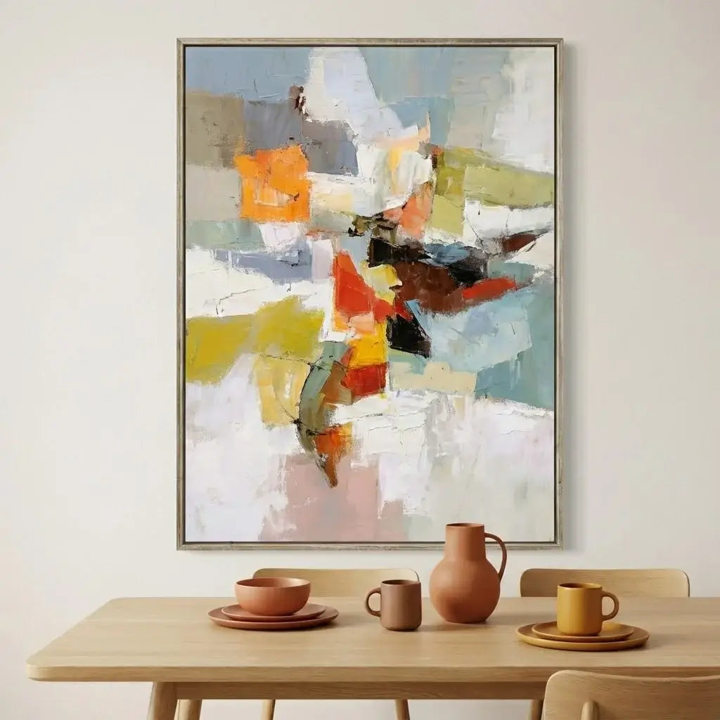 Abstract painting above a dining table with ceramic items