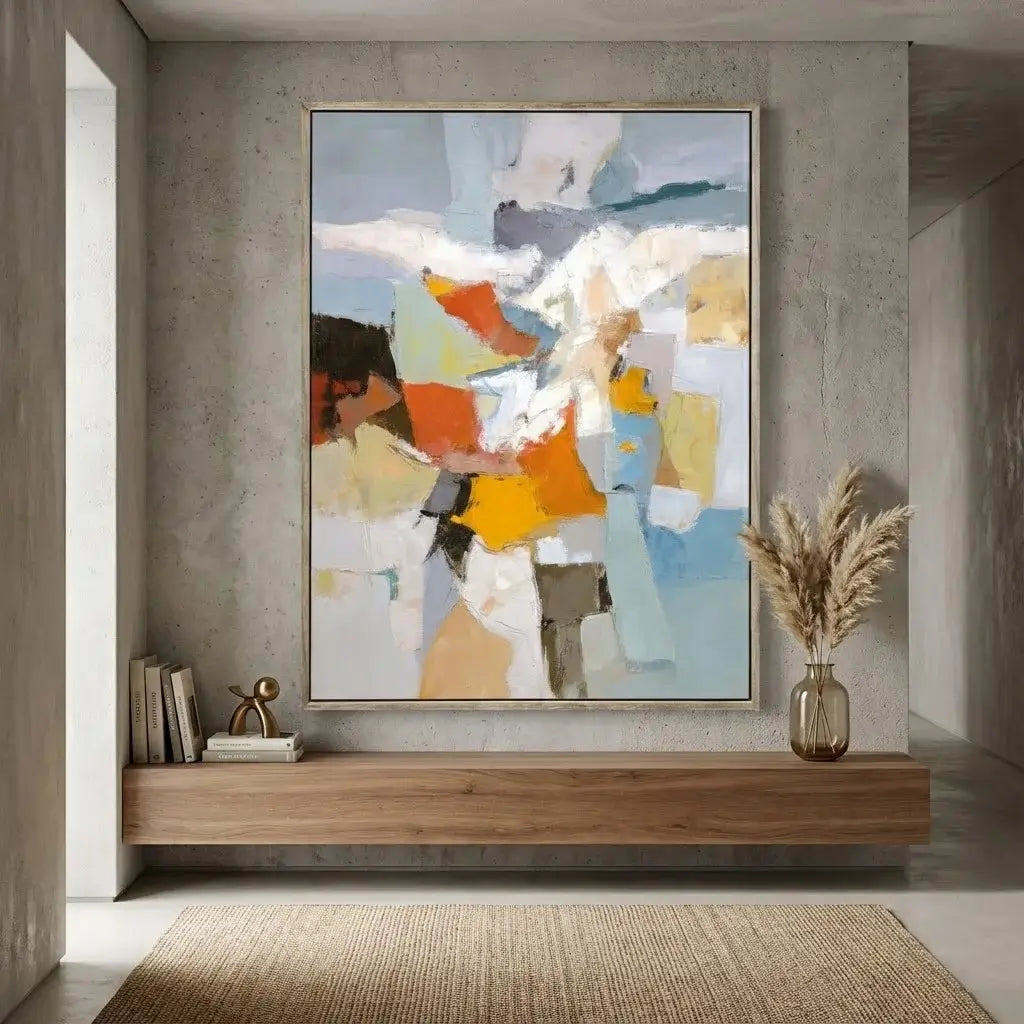 Abstract art piece on a wall in a modern interior setting with a wooden shelf and decorative items.