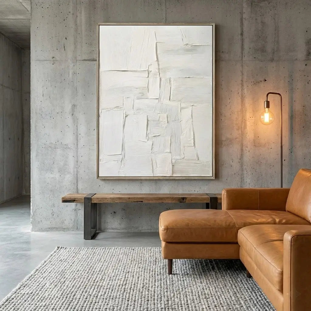 Modern living room with a brown leather sofa, abstract painting, and concrete wall.