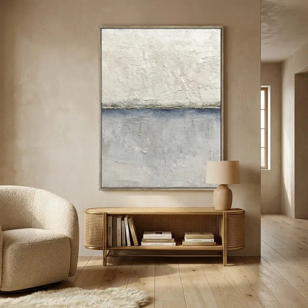 Modern living room with abstract painting, armchair, and wooden side table.