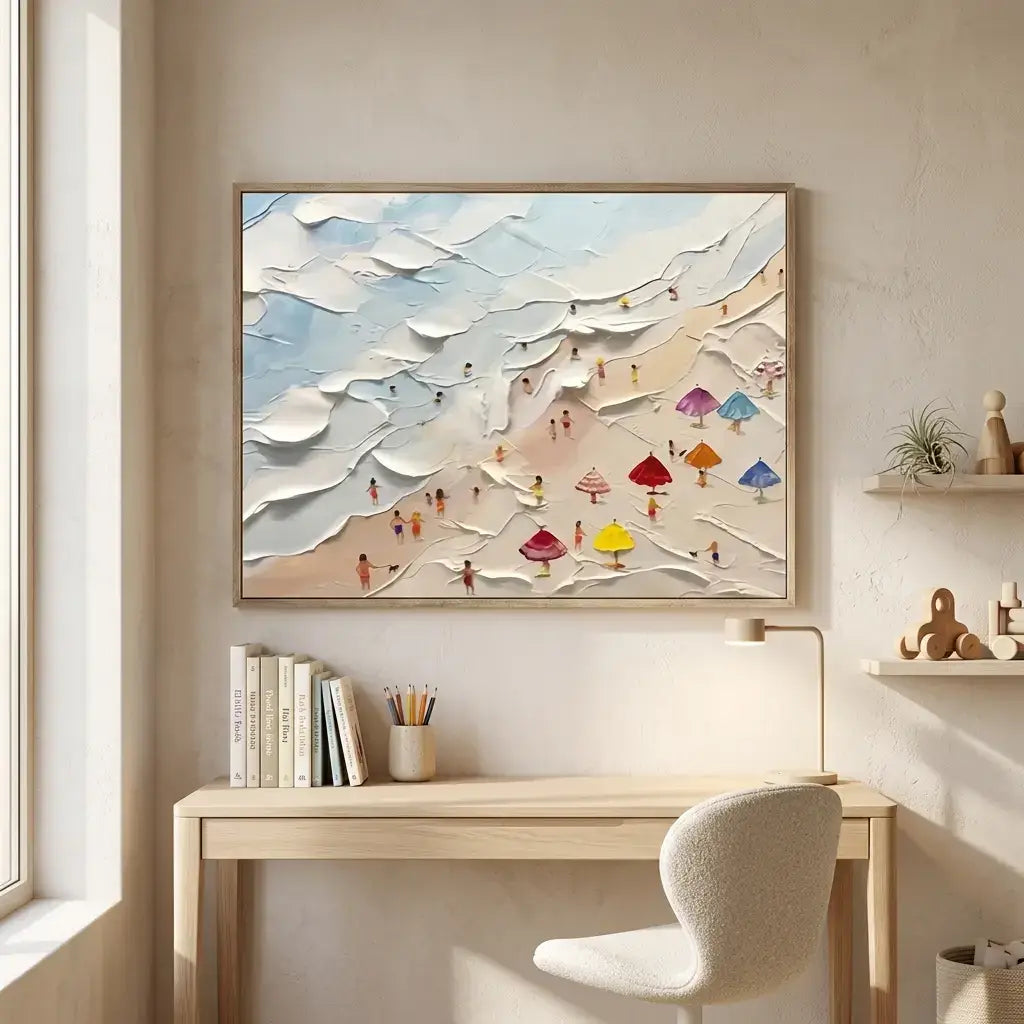 Framed abstract artwork above a desk with books and a chair in a bright room.