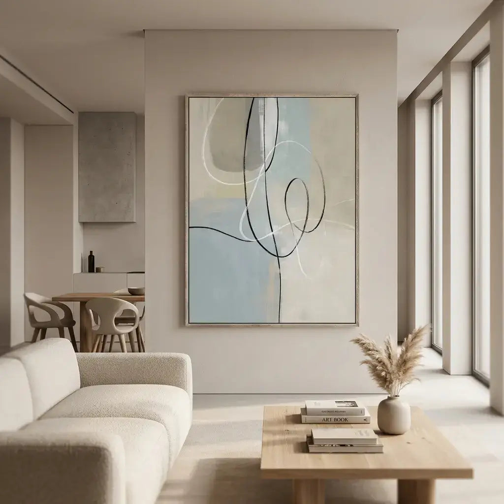 Modern living room with abstract art on the wall, neutral color palette.