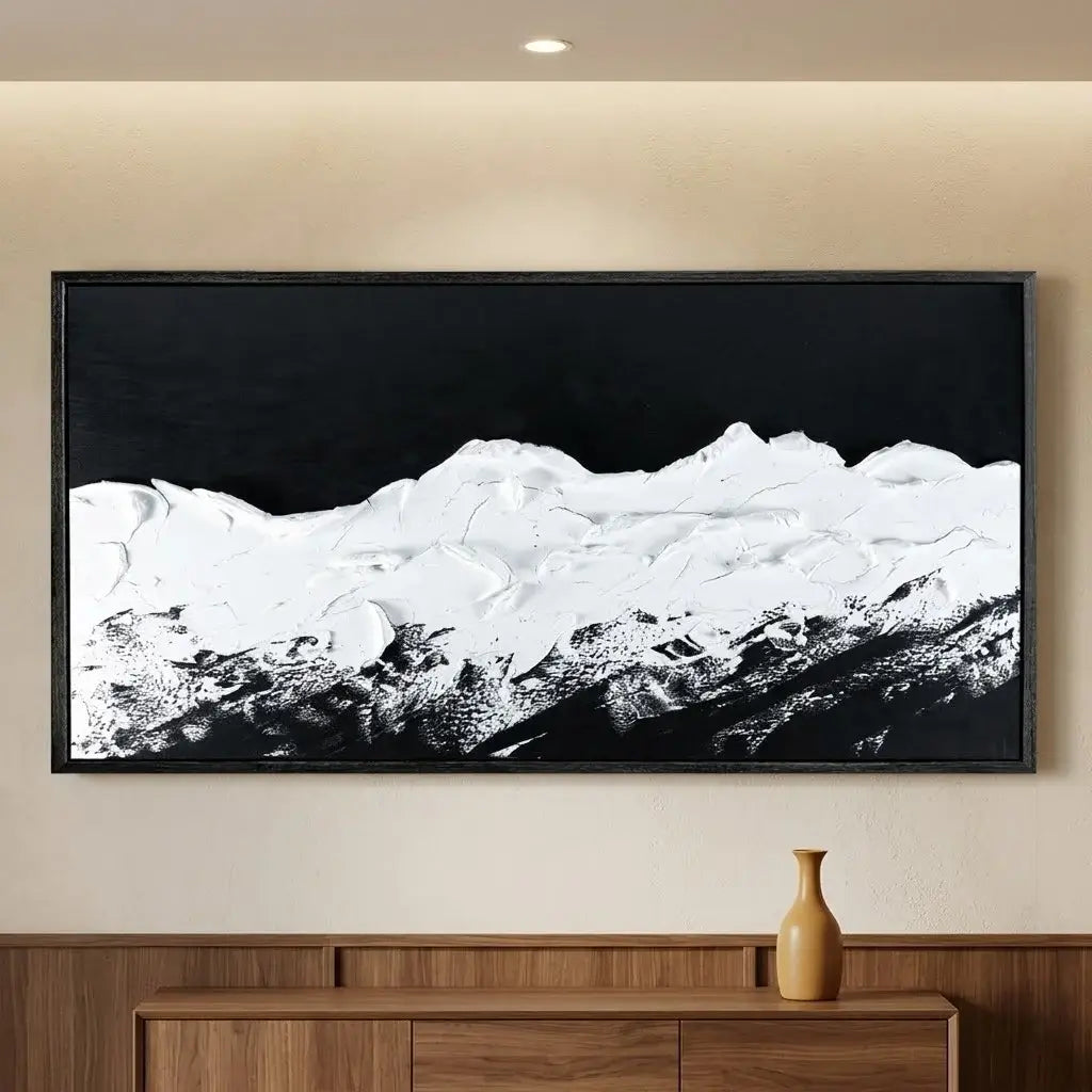Framed landscape artwork on a brick wall above a brown leather chair.
