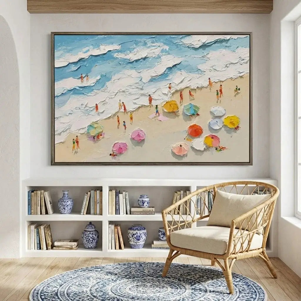 Beach-themed artwork above a bookshelf with a wicker chair and rug in a room.