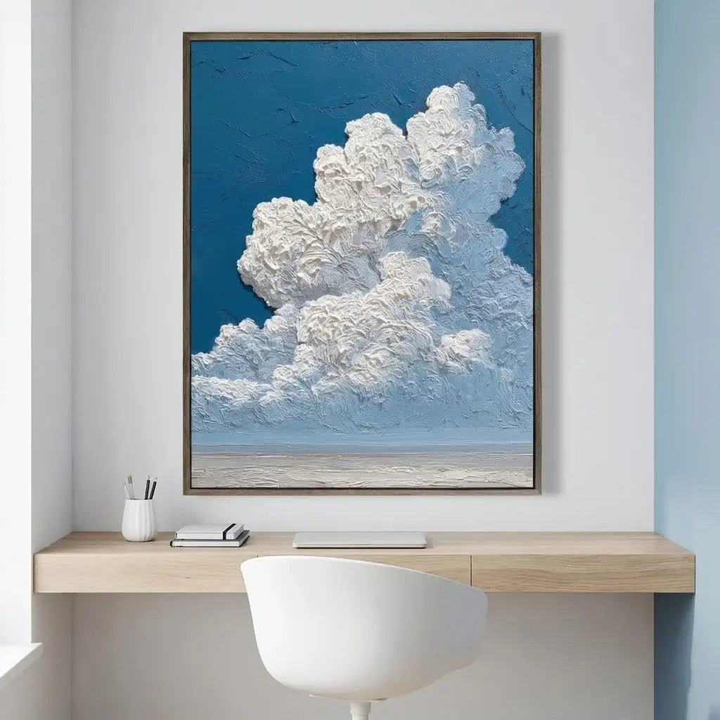Framed artwork of a cloud over a desk with a chair
