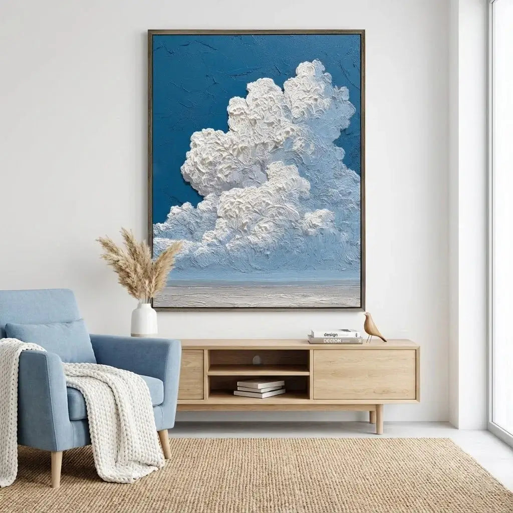 Modern living room with a blue armchair, wooden TV stand, and large framed artwork of clouds.