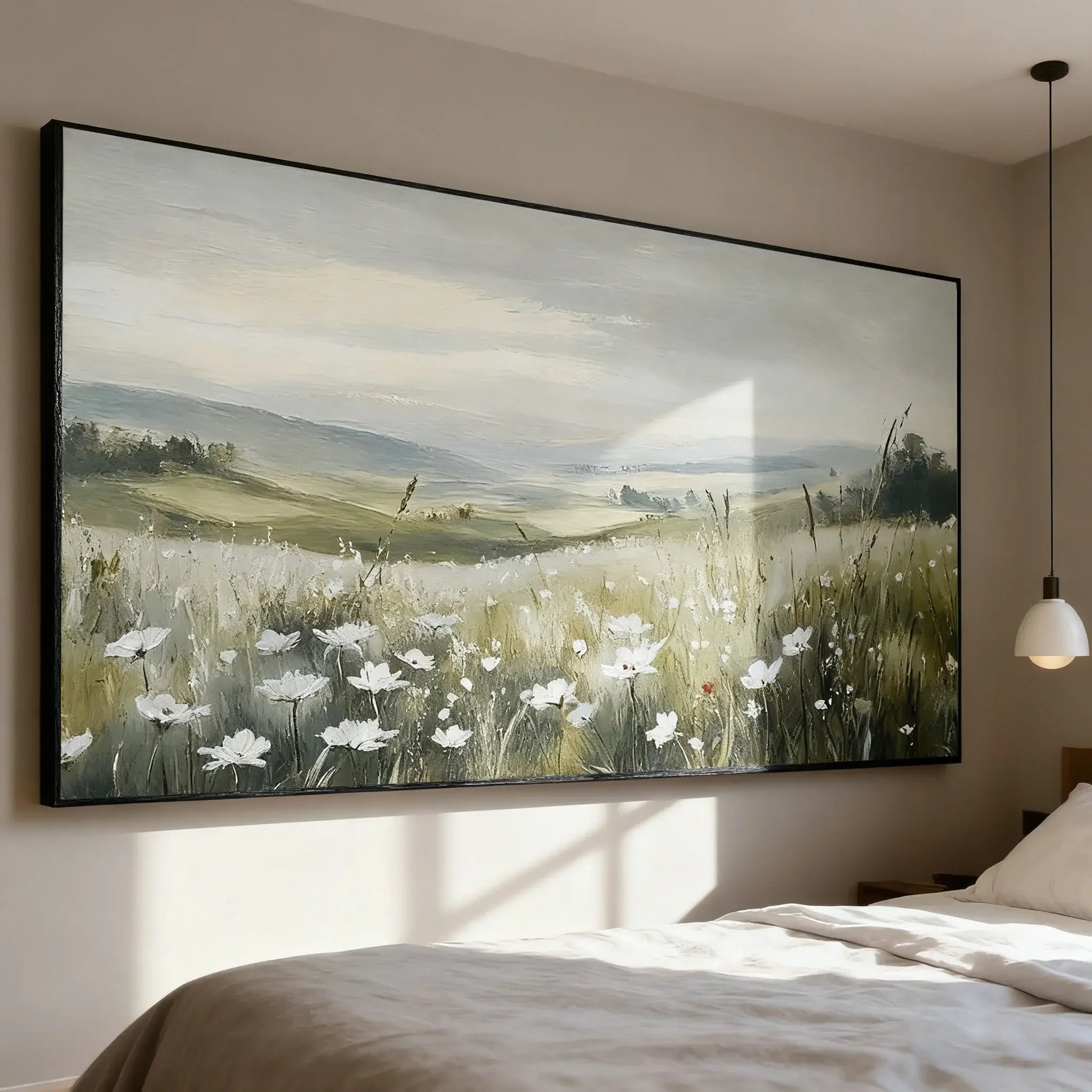 Large landscape painting of a field with flowers on a wall above a bed.