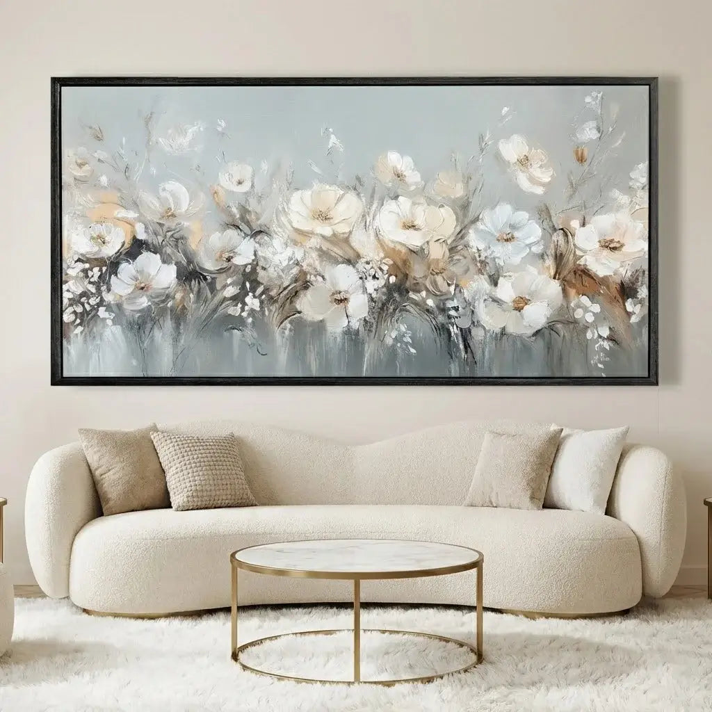 Framed floral artwork above a beige sofa in a living room.