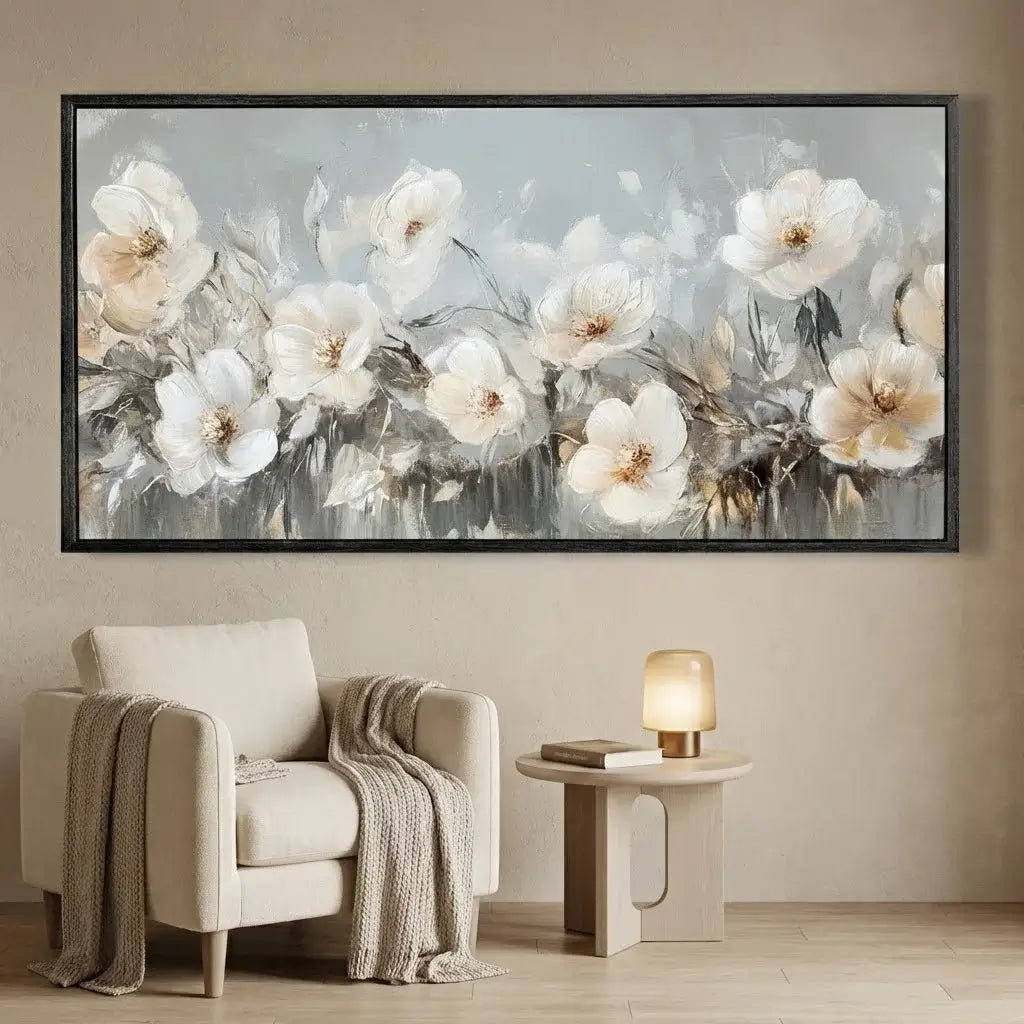 Framed floral artwork above a beige armchair in a room with a side table.