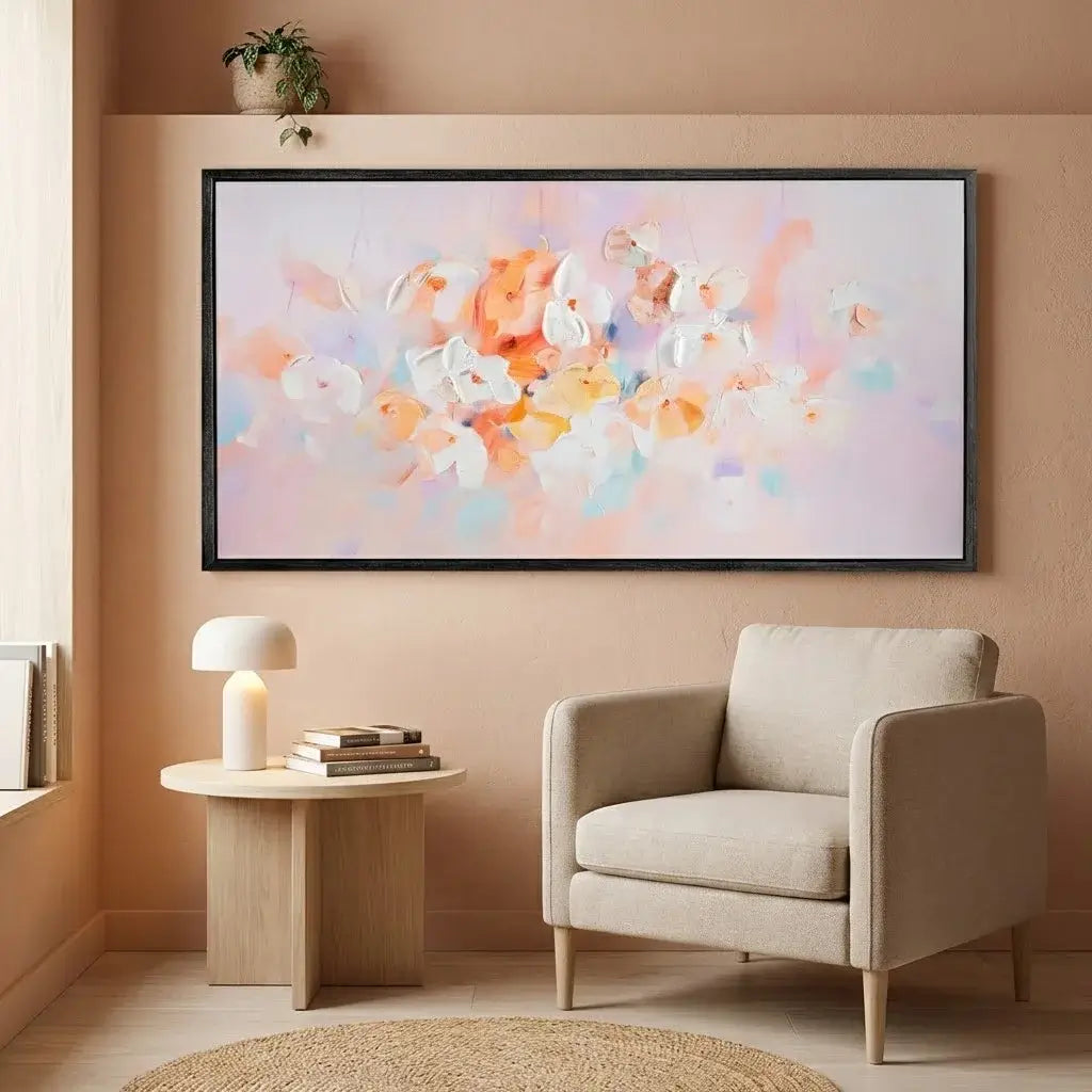 Modern living room with a beige armchair, side table, and abstract floral artwork on the wall.