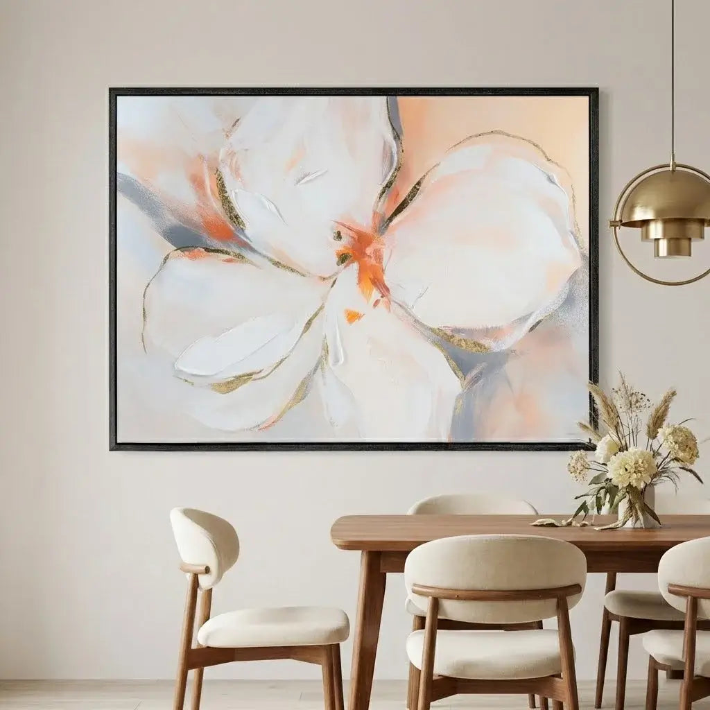Framed abstract floral artwork above a dining table with chairs.
