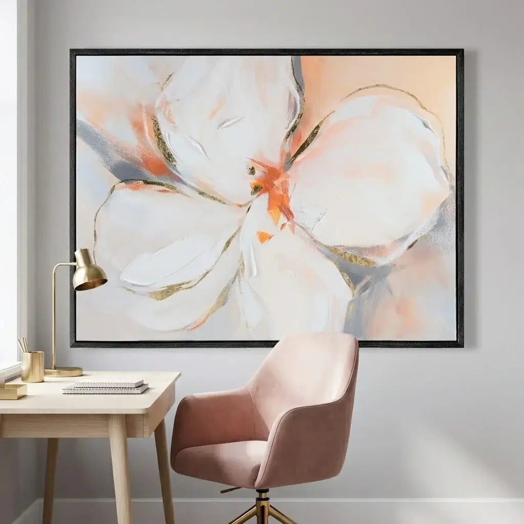 Framed abstract floral artwork on a wall above a desk with a chair.