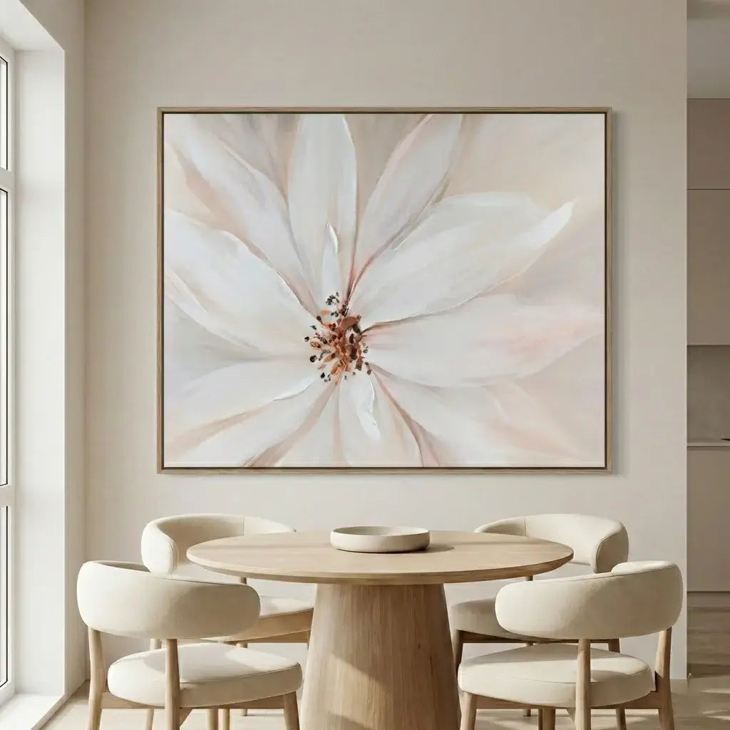 Dining room with a large floral painting on the wall above a round wooden table and chairs.