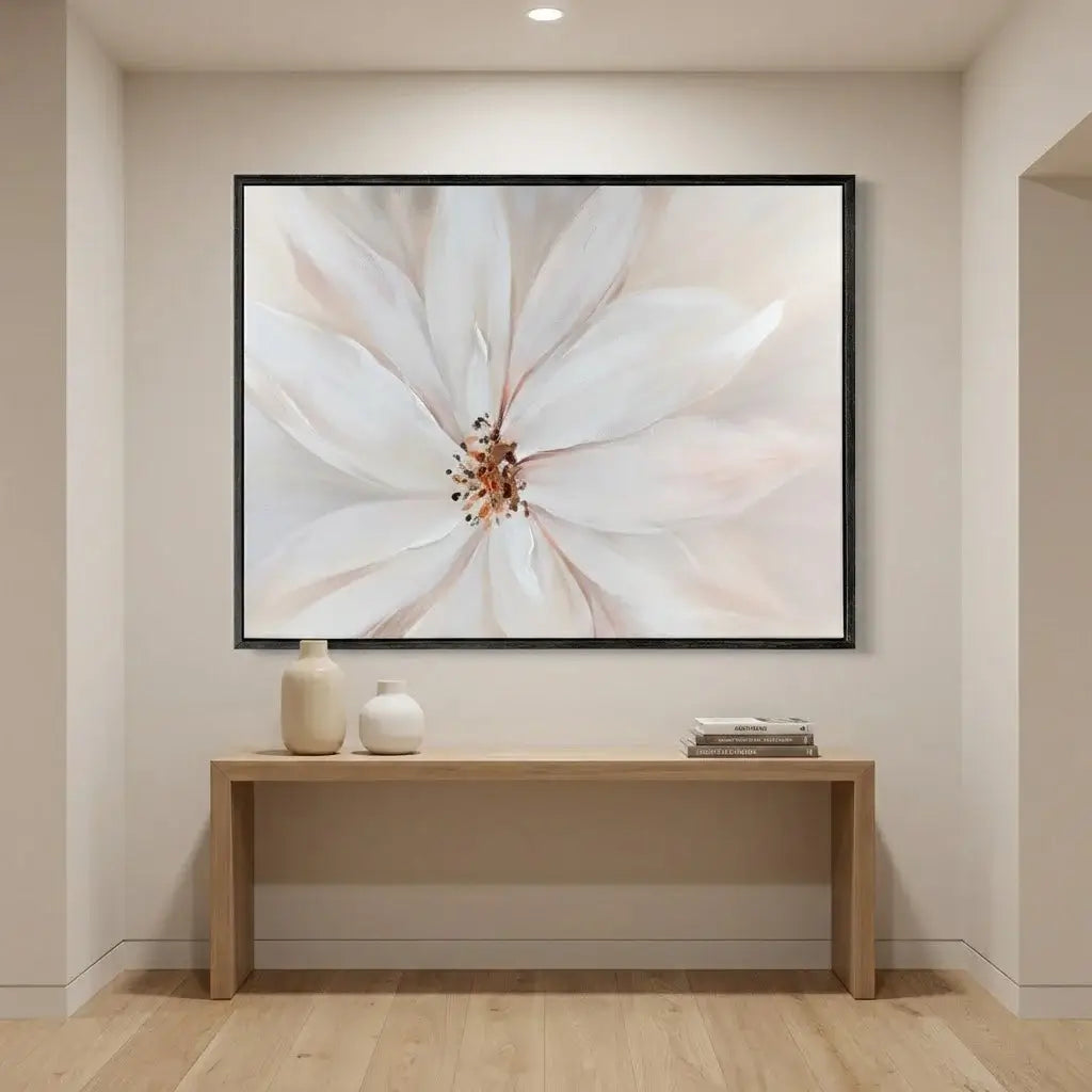 Framed floral artwork on a wall above a wooden console table.