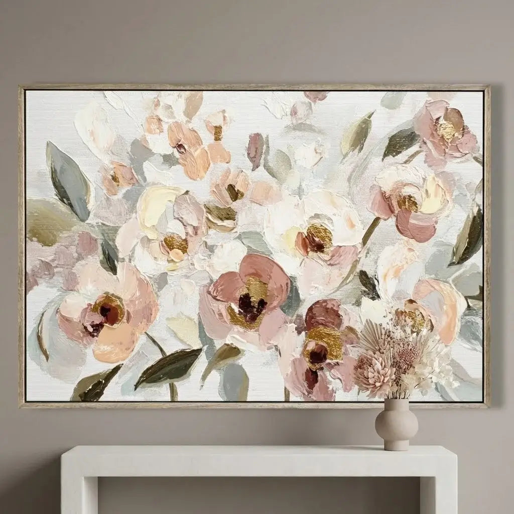 Framed floral artwork on a wall above a white console table.