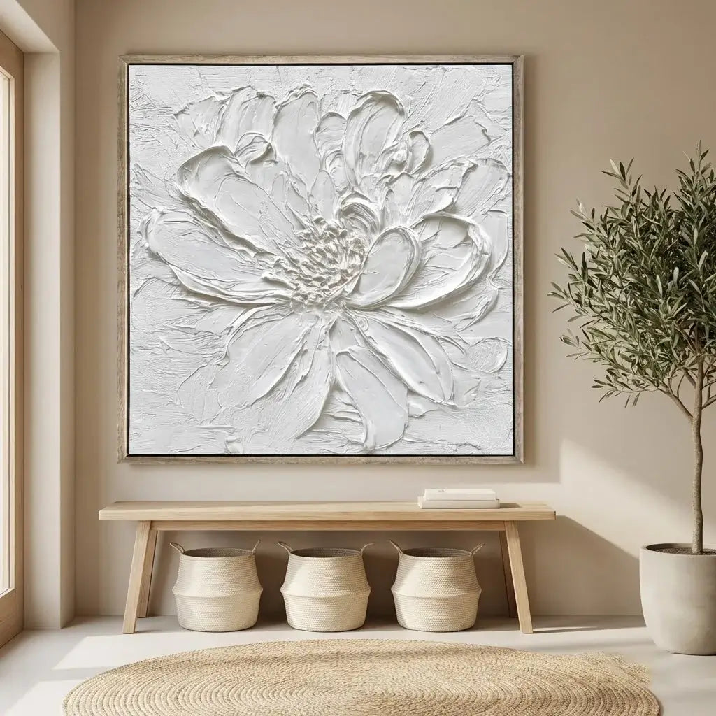 Decorative wall art of a textured flower in a neutral setting with plants and a bench.