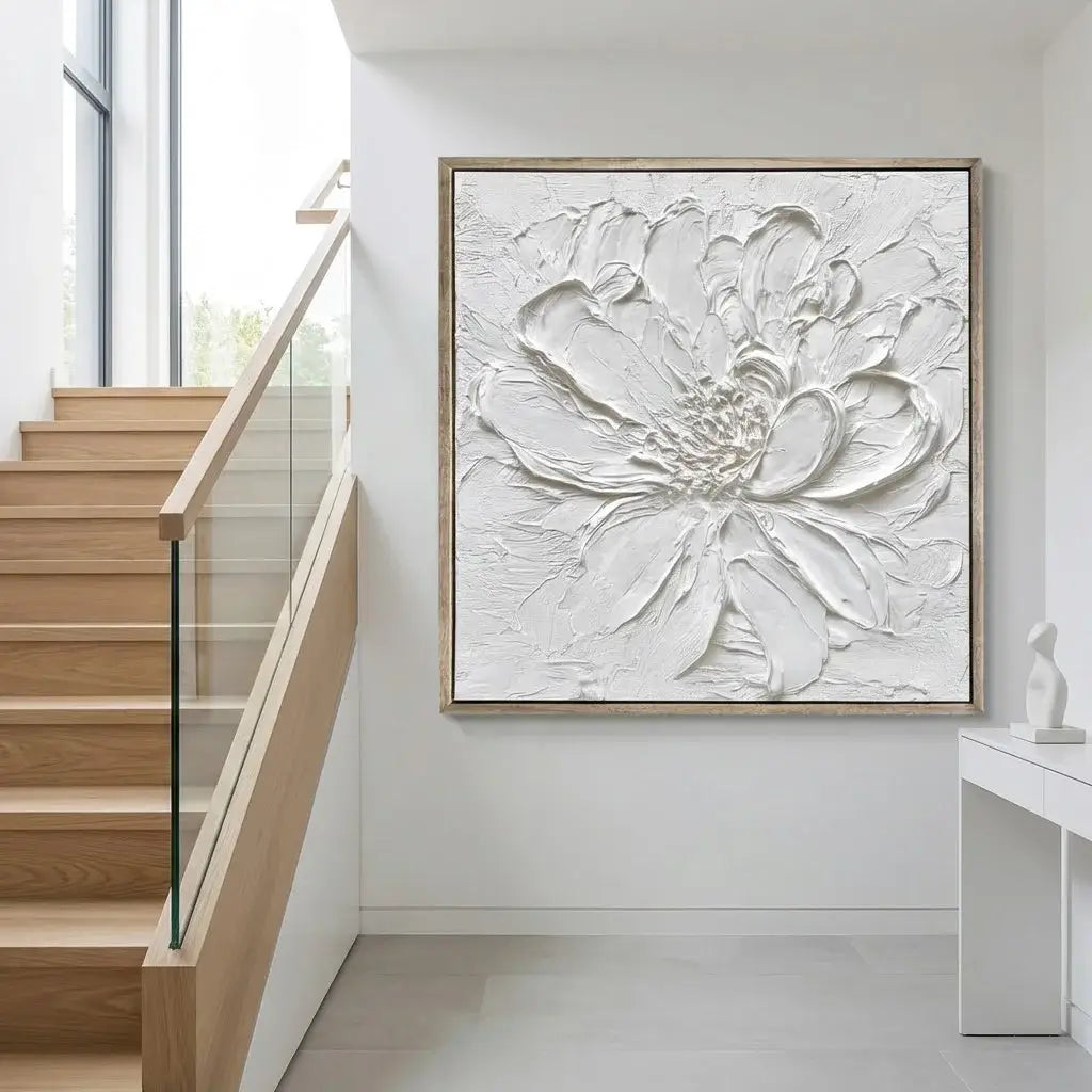 Framed abstract floral artwork on a wall in a modern interior setting with stairs.