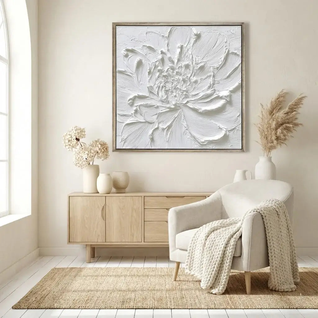 Modern living room with a large floral artwork on the wall, a white armchair, and wooden sideboard.
