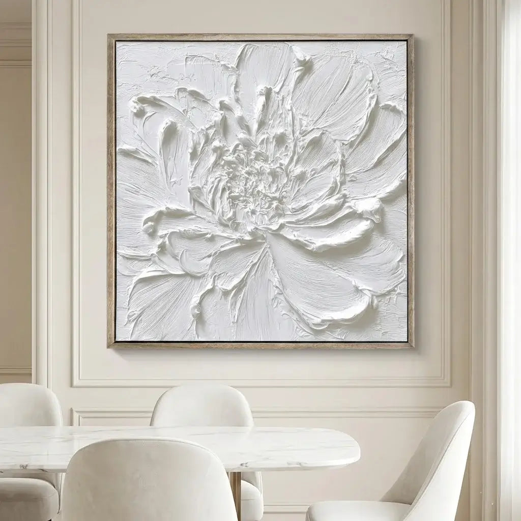 Framed abstract floral artwork on a wall above a dining table with chairs.