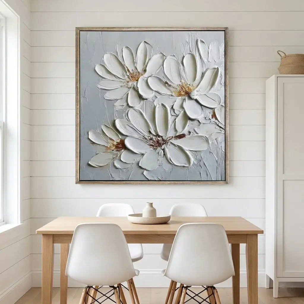 Dining room with a large floral painting on the wall above a wooden table and chairs.