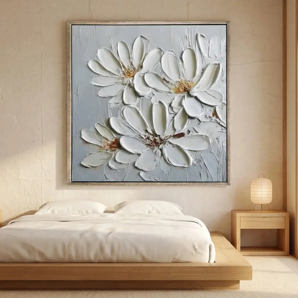 Framed floral artwork above a bed in a bedroom setting