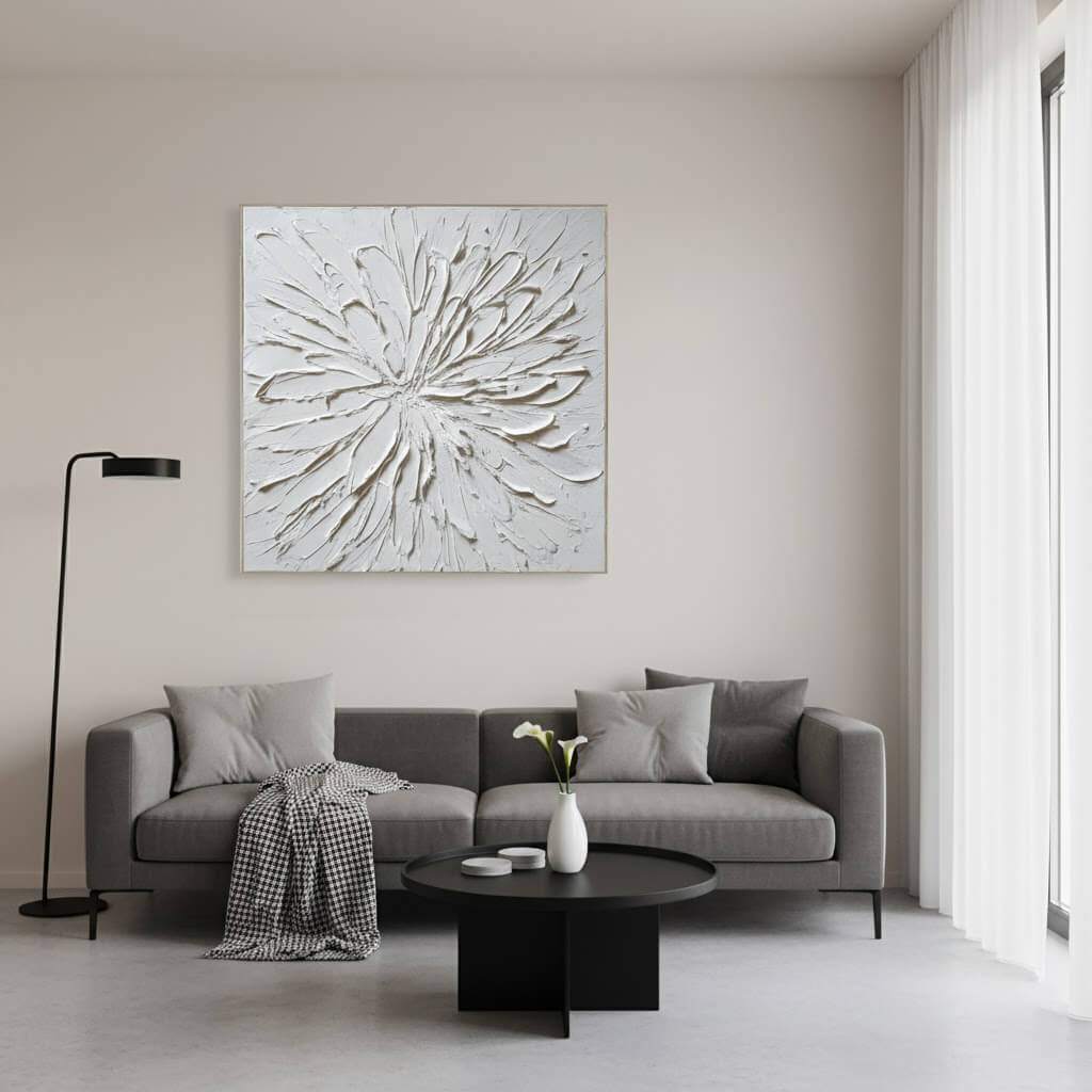 Modern living room with a gray sofa, round coffee table, and abstract wall art.