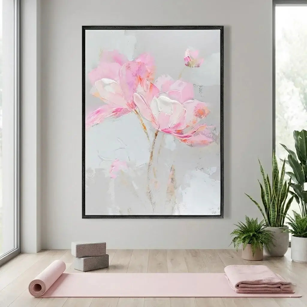 Framed floral artwork on a wall with yoga mat and towels below