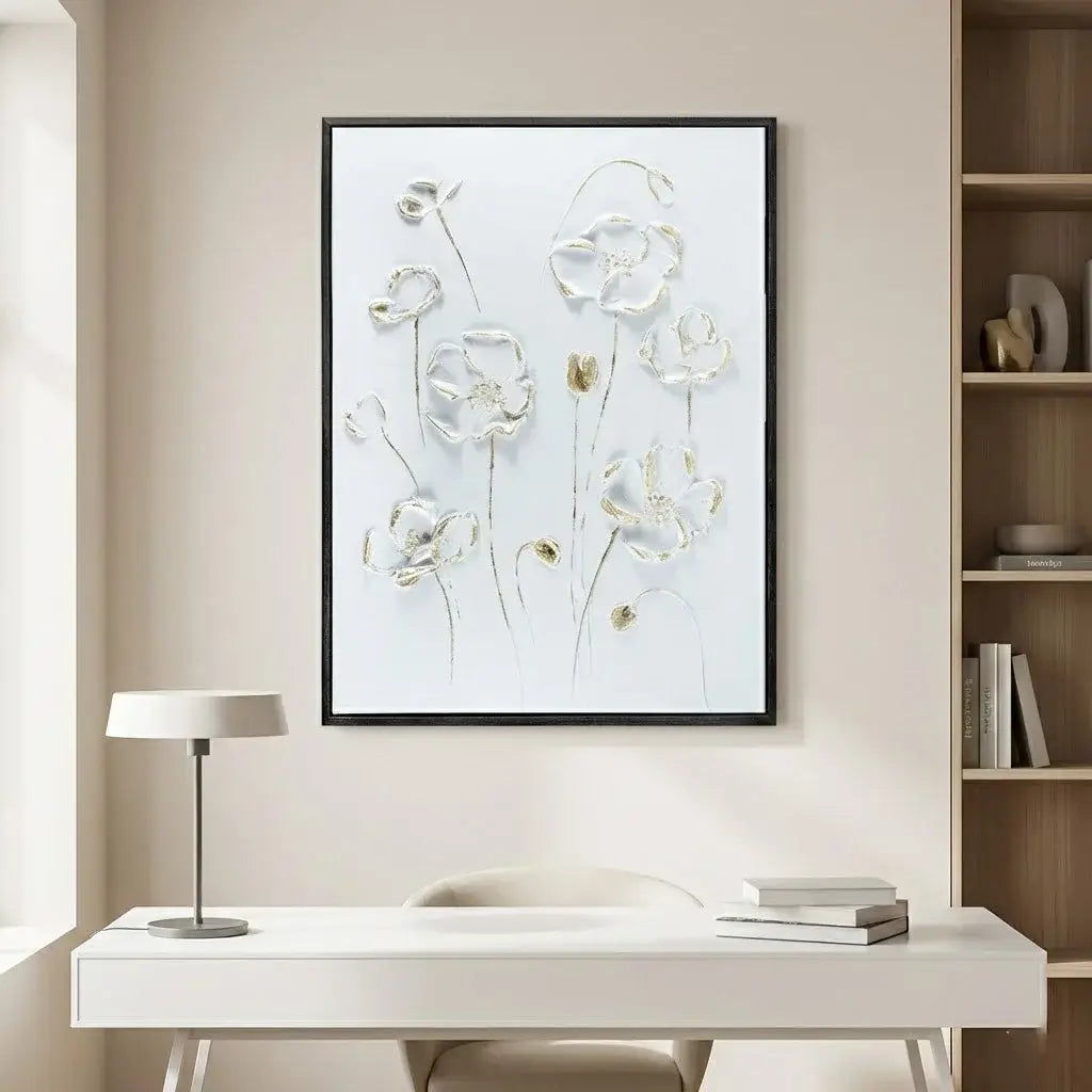 Framed floral artwork on a wall above a desk in a home office setting.