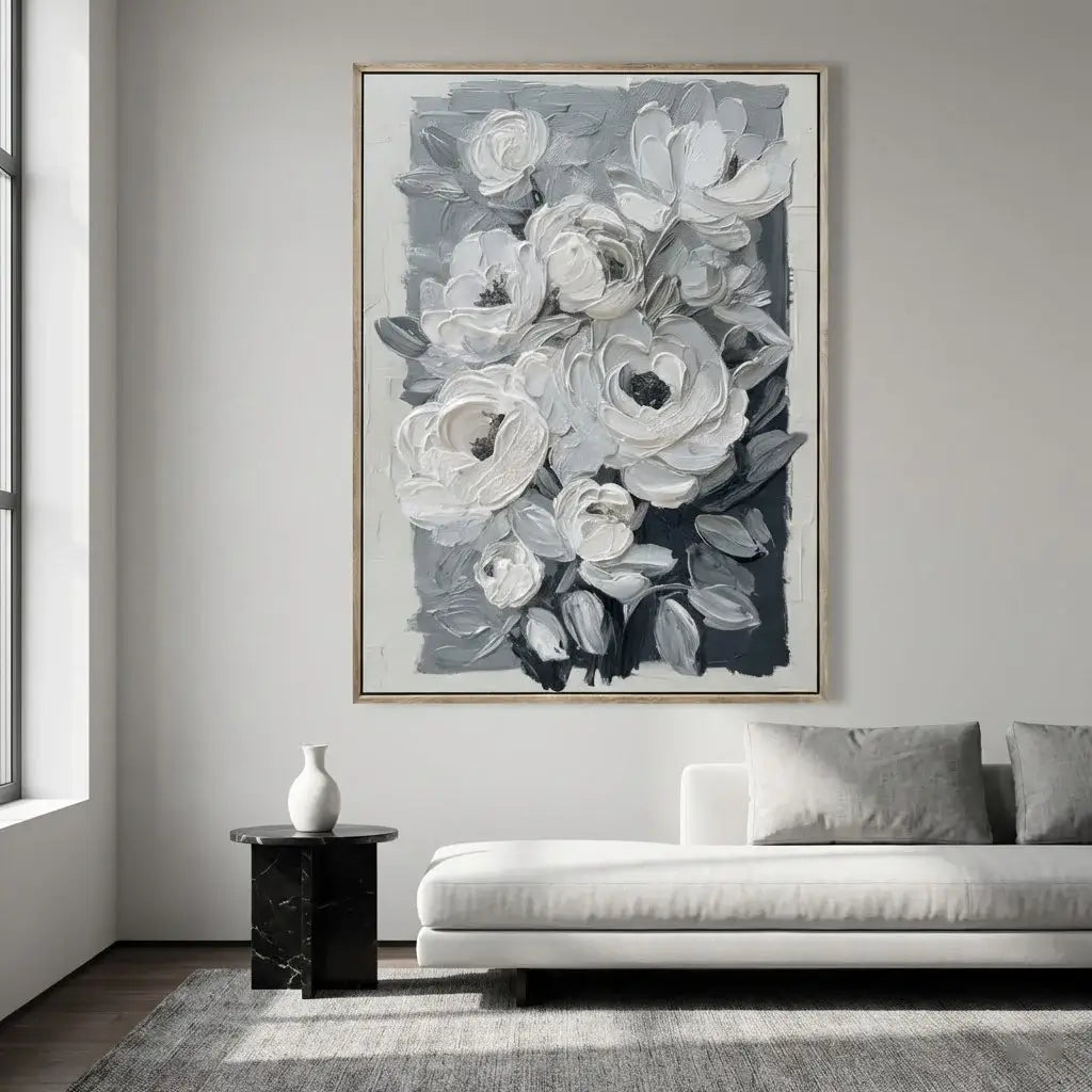 Floral artwork in a living room with a sofa and side table.
