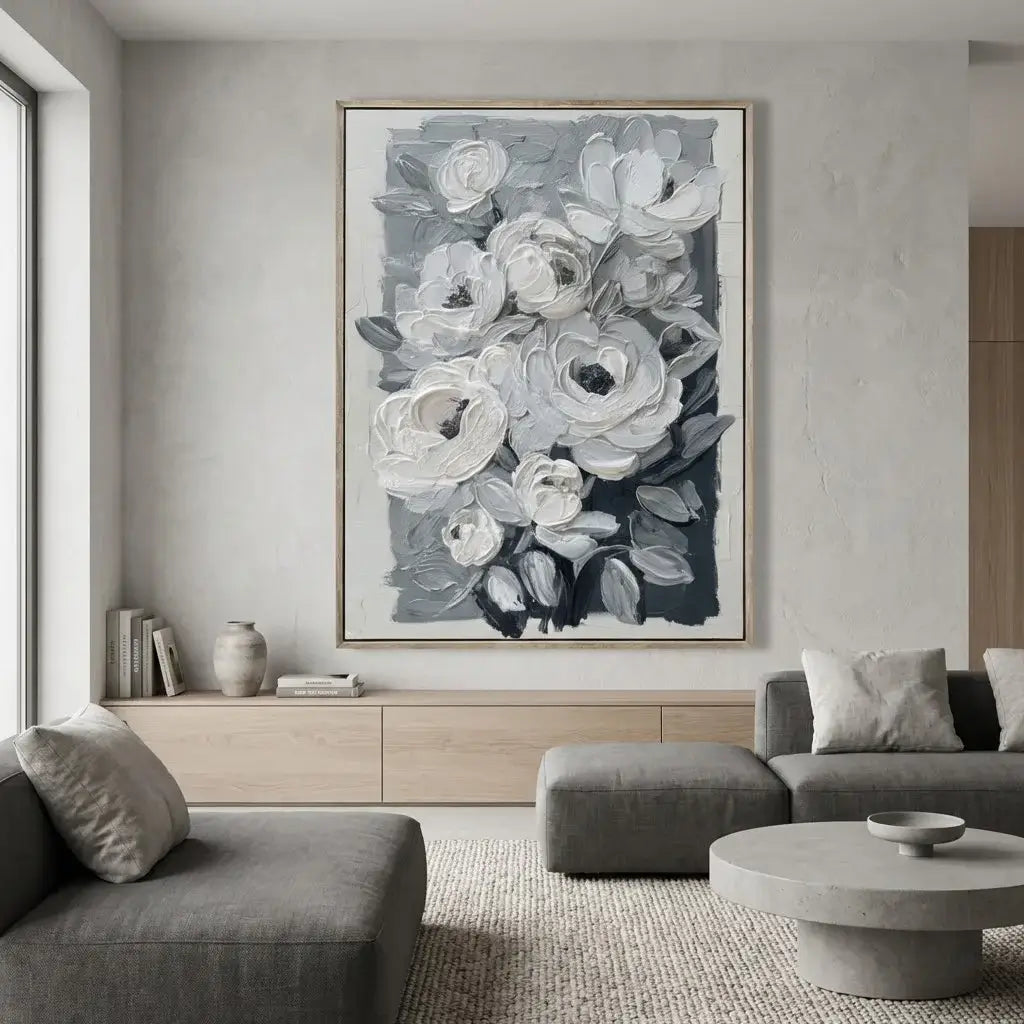 Living room with gray sofa, round coffee table, and floral artwork on the wall.