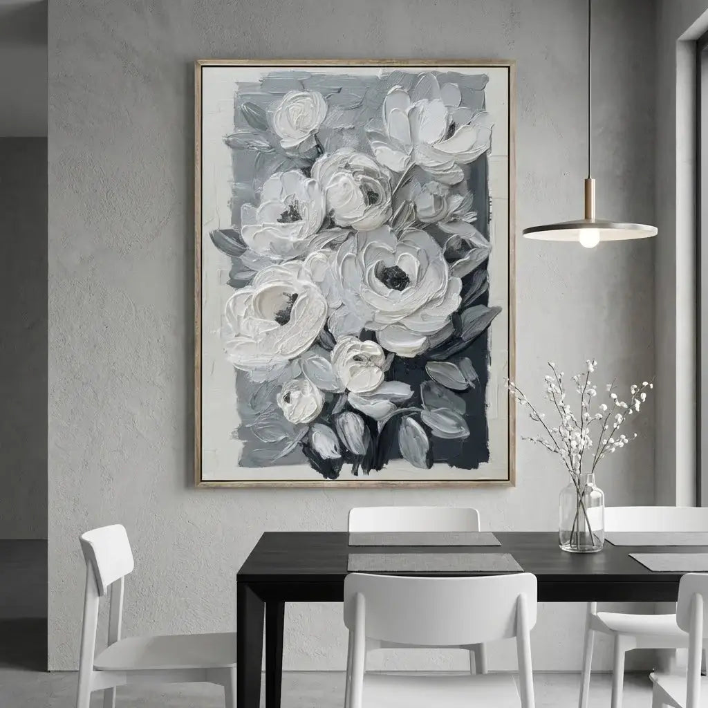 Dining room with a large floral painting on the wall, black table, and white chairs.